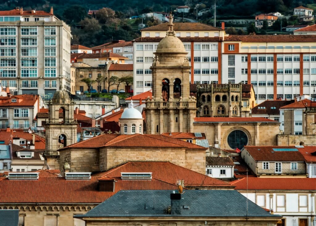 Panoramic view of historical architecture in Ourense, showcasing church towers against modern buildings.