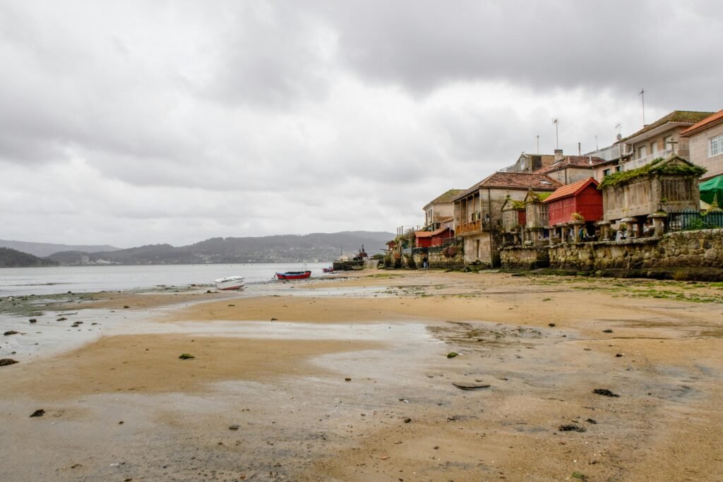 Explore the historic seaside charm of Combarro, Galicia with rustic buildings by the beach.
